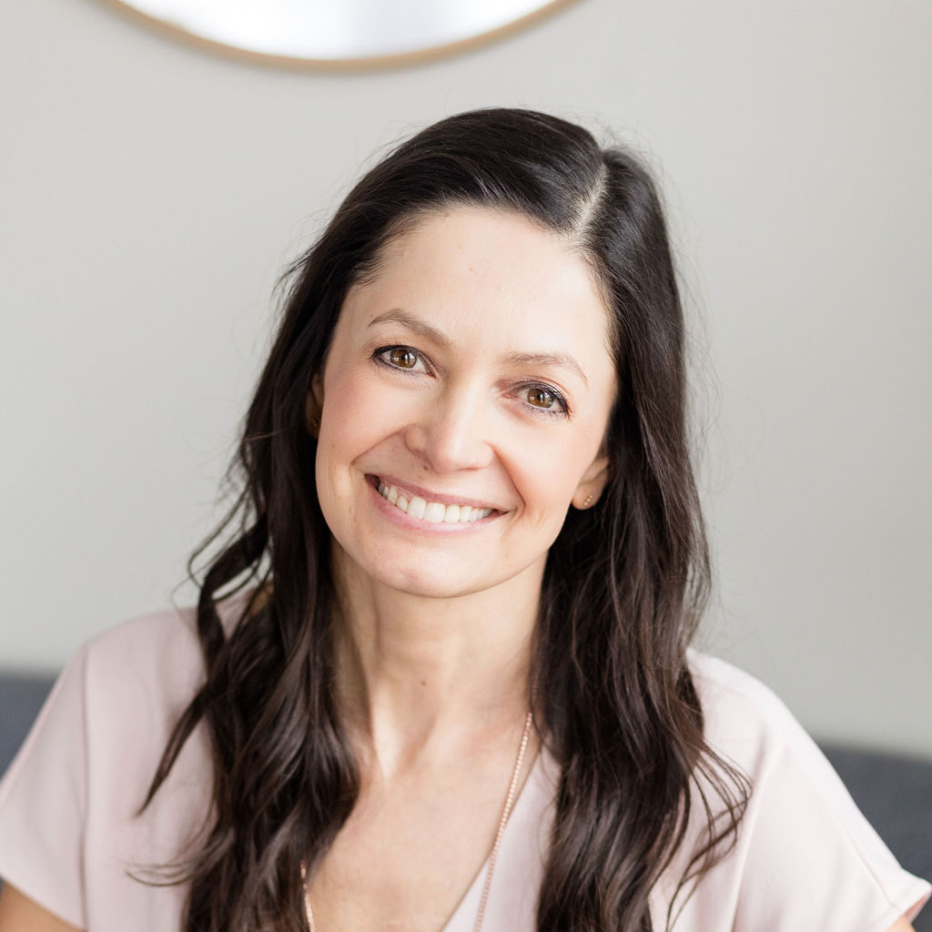 Vallie Aris, nationally board-certified acupuncturist and herbalist at Eau Claire Acupuncture, [smiling at the camera in a bright clinic setting]